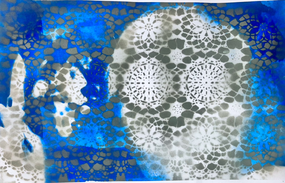 Abstract cyanotype artwork featuring intricate white lace-like patterns against a vibrant blue background, creating circular mandala forms with delicate geometric details.